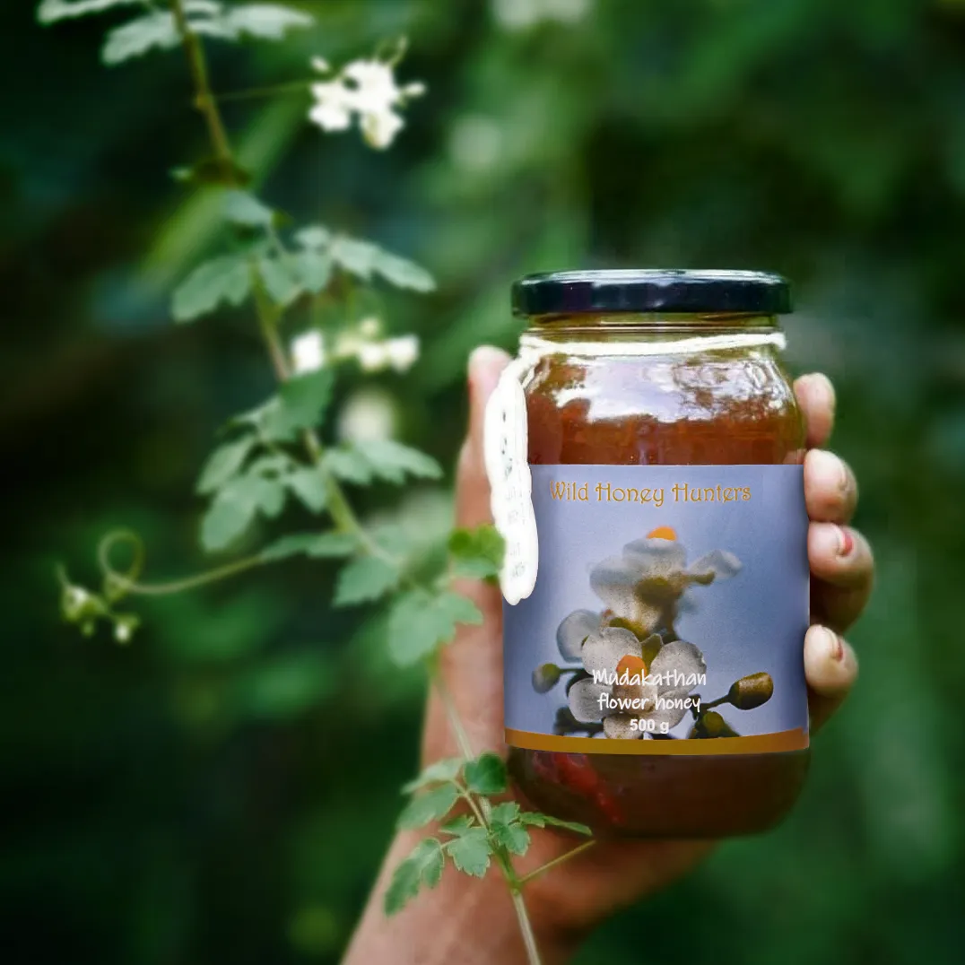 wonen holding Mudakathan seasonal honey bottle