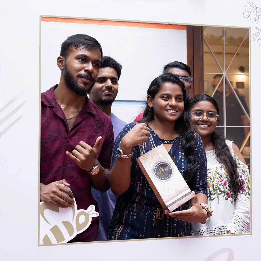 Visitors exploring natural honey varieties at a Ghats Honey awareness event