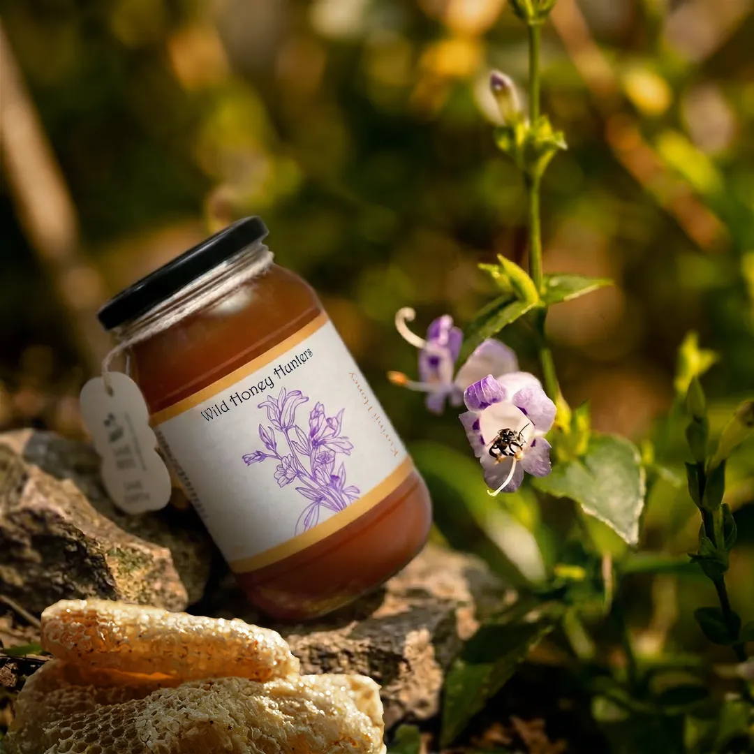 Pure Kurinji honey bottle placed in a natural forest background