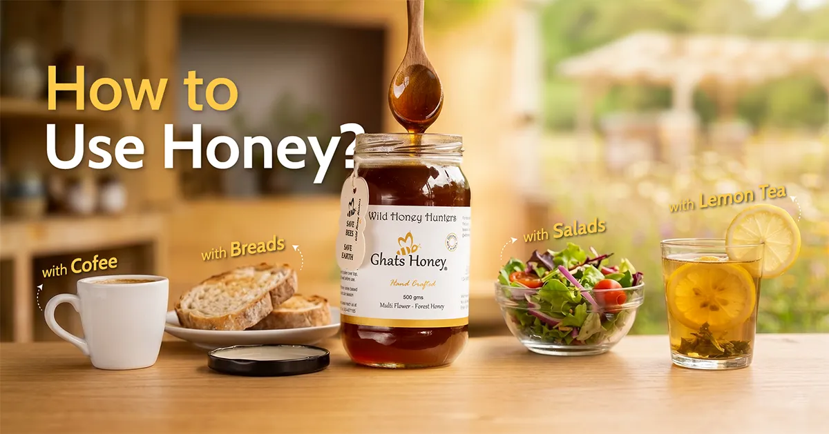 A jar of Ghats Honey with honey dripping from a wooden spoon, surrounded by a cup of coffee, sliced bread, a fresh salad, and lemon tea, showing different ways to use honey in daily foods and beverages.