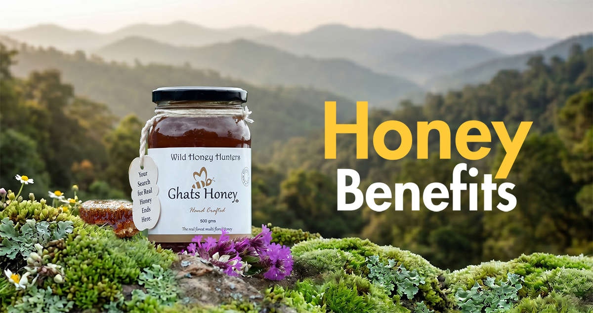Ghats Honey multiflower honey bottle placed on a natural mossy background with flowers and large text reading “Honey Benefits.”